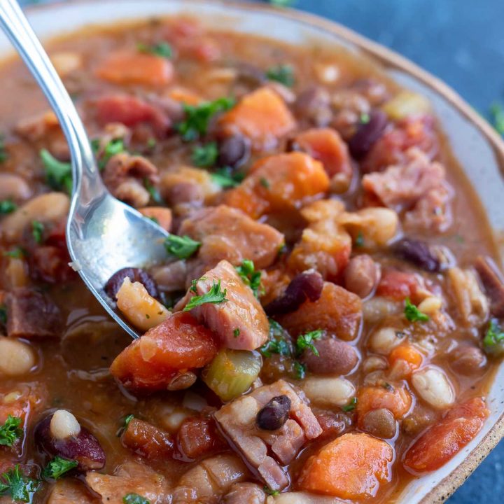 spoon scooping ng into ham bean soup