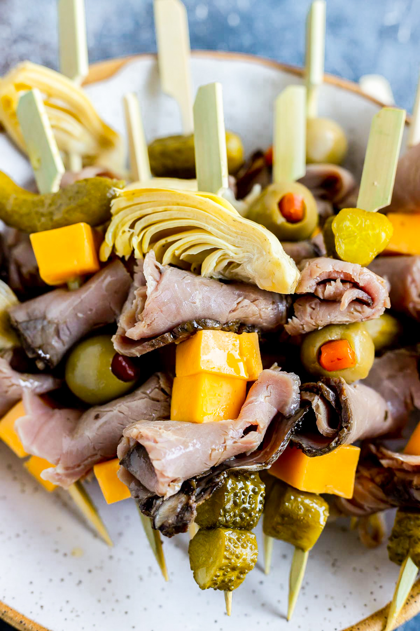 deli meat, pickles and cheese on wood skewer