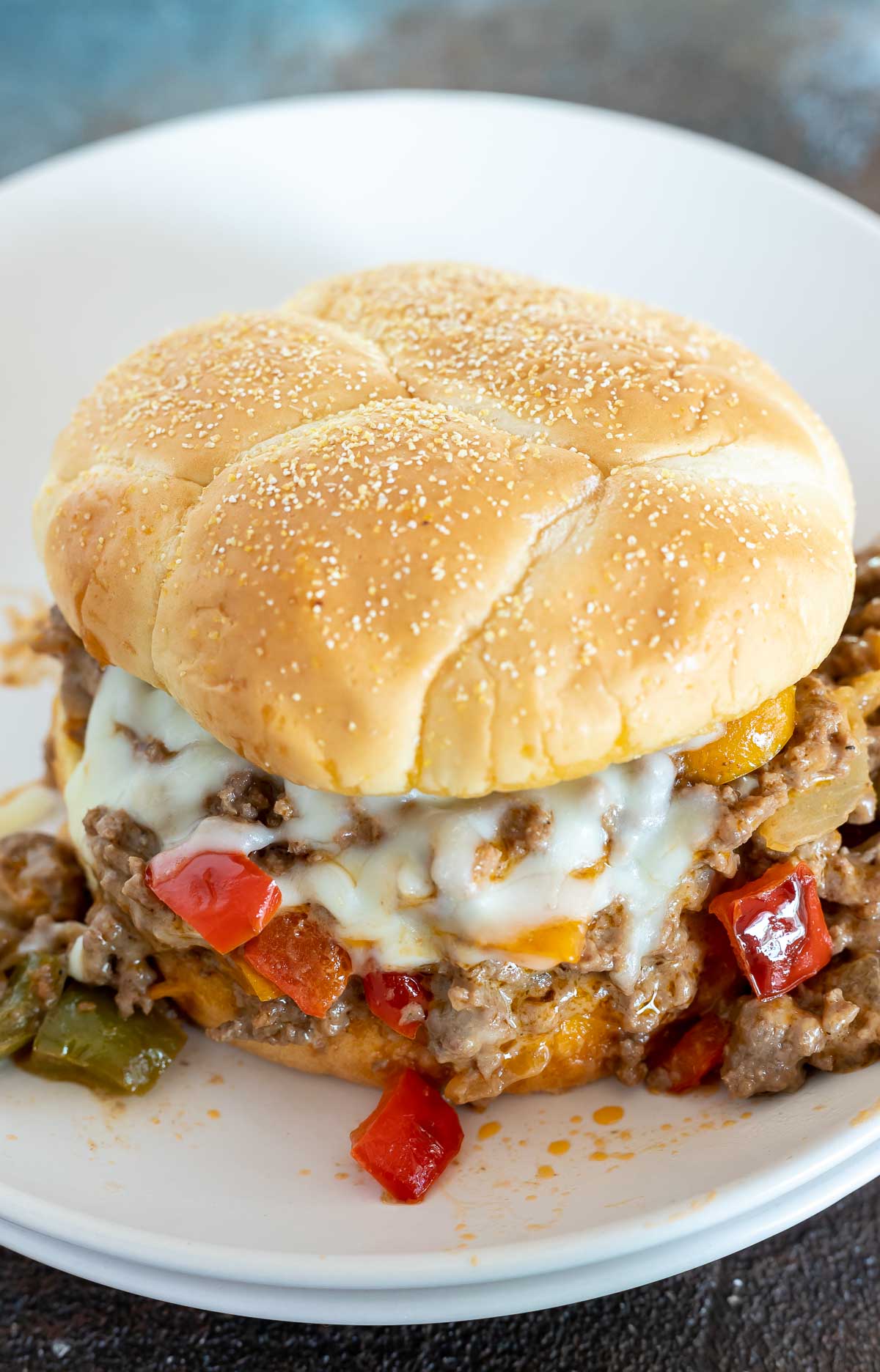 ground beef, peppers and cheese on toasted bun