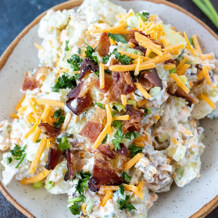 cheese and bacon potato salad in white bowl
