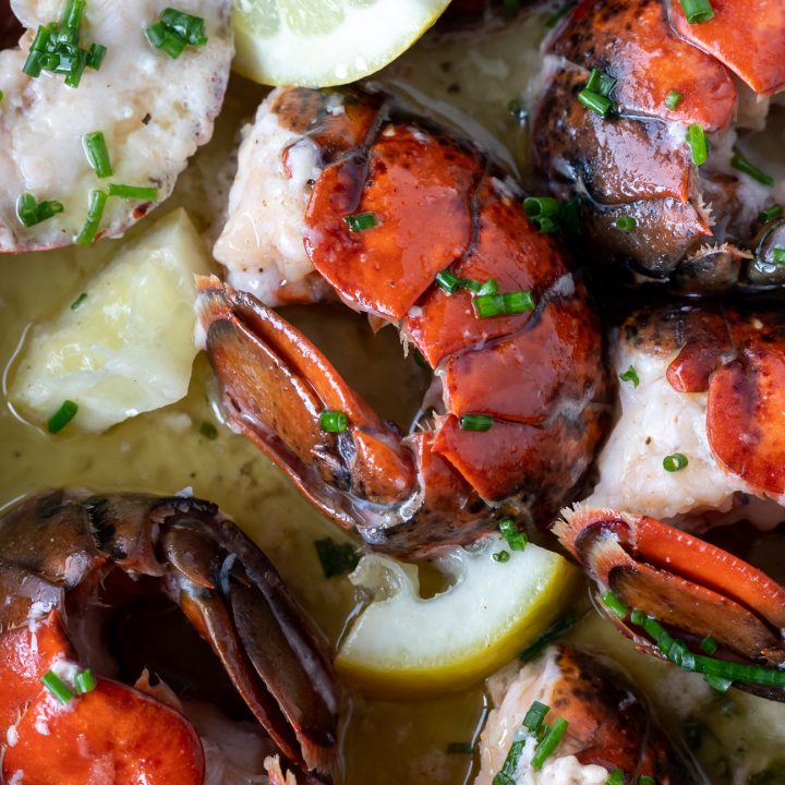 cooked lobster in the shell with butter and lemons