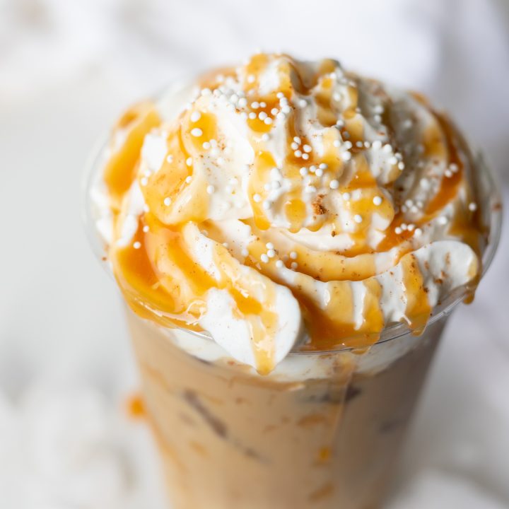 eggnog latte topped with whipped cream and caramel sauce