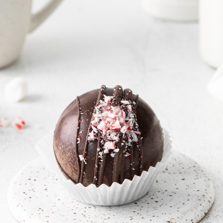 prepared cocoa bomb topped with crushed candy cane