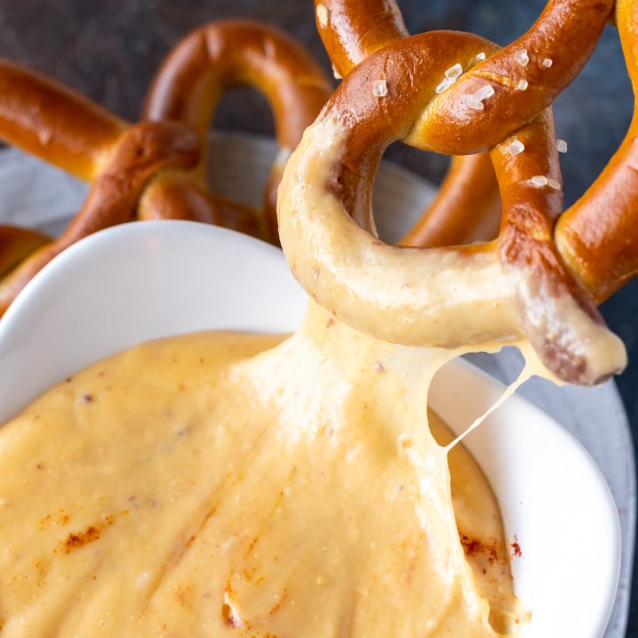 soft pretzel dipped in cheesy sauce