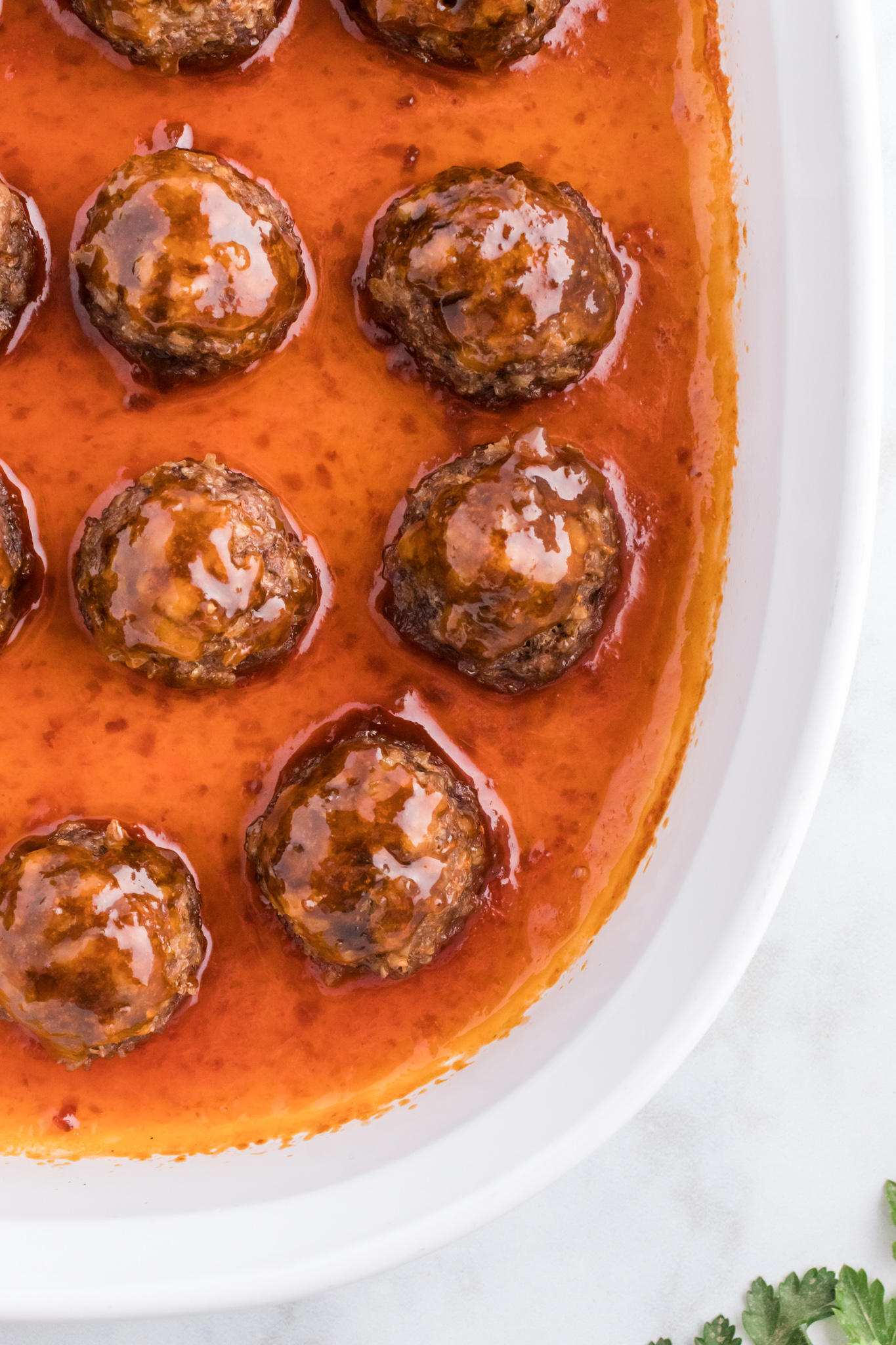 meatballs in sauce in white dish