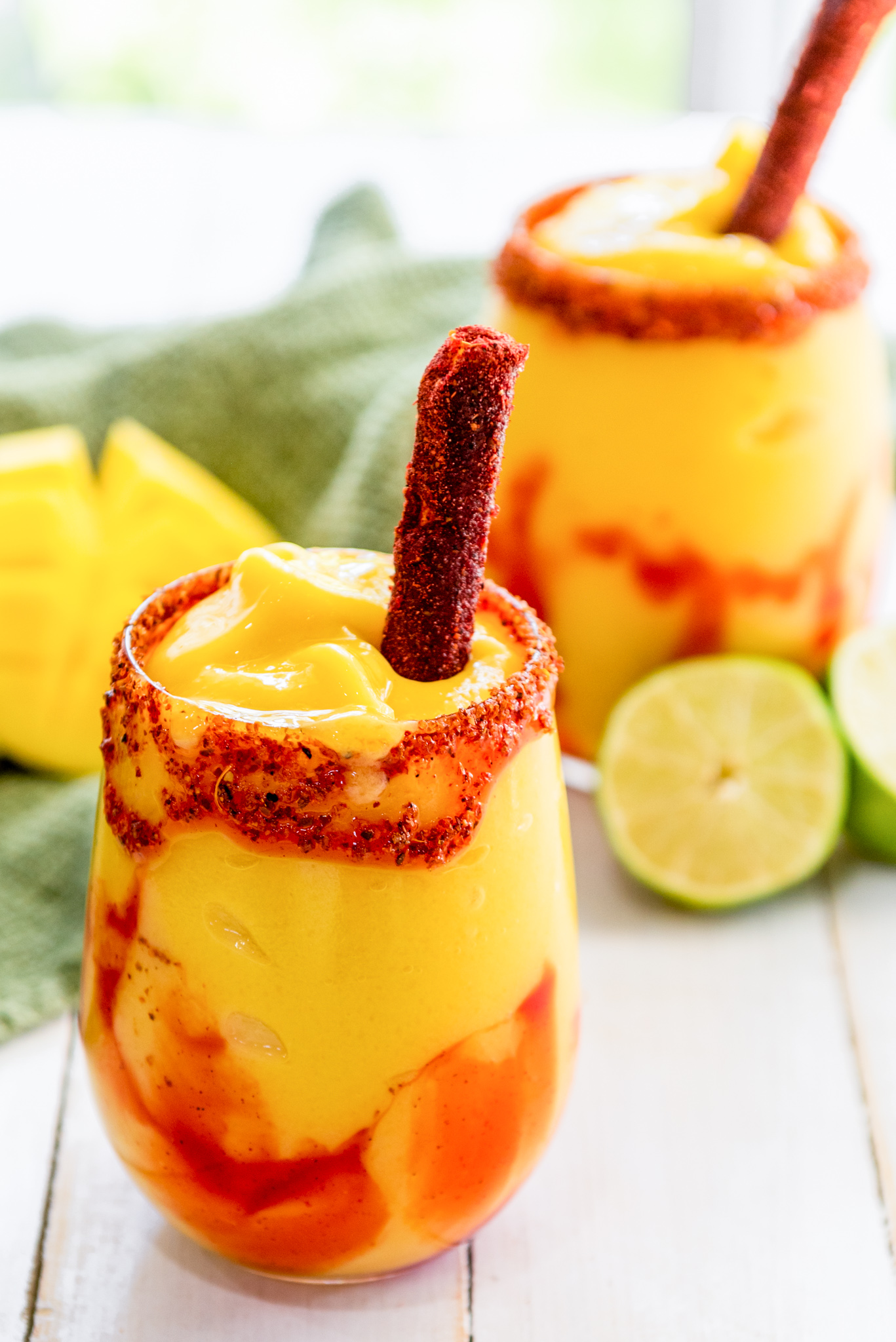 orange and red drink with red spiced straw