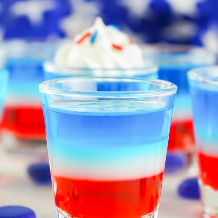 clear shot glass filled with red white and blue jello