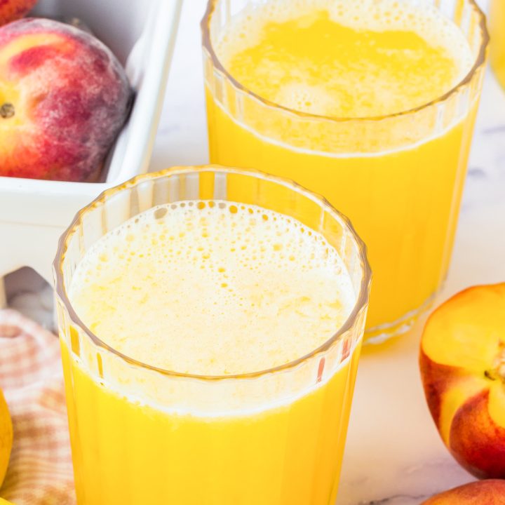 two glasses with orange liquid