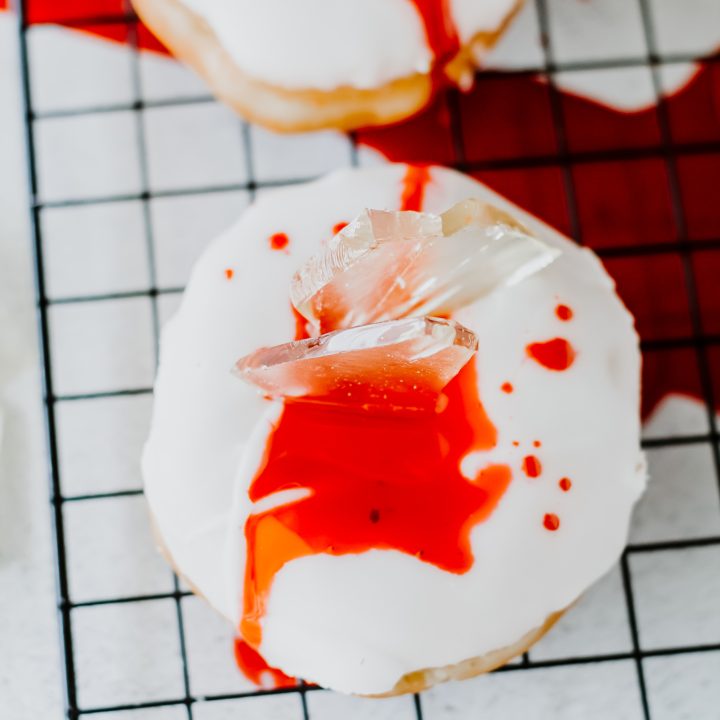 white donuts topped with candy shards and red corn syrup