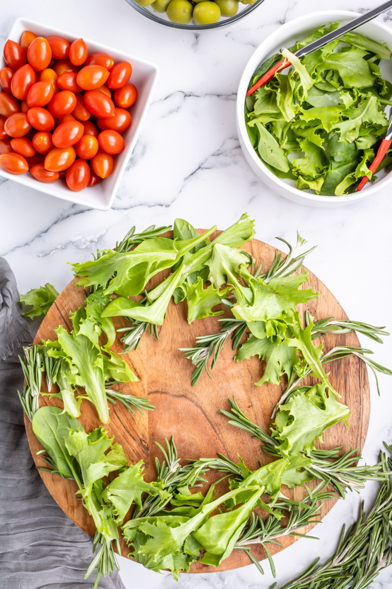 greens and rosemary shaped into a wreath circle