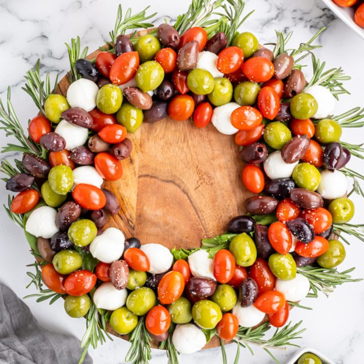 olives and cheese arranged into a circle shape on platter