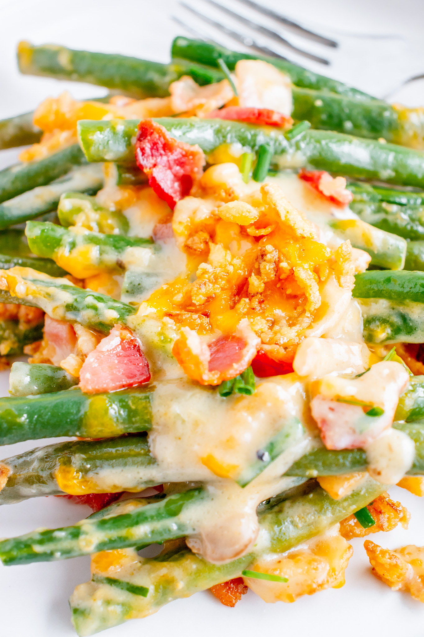 green beans topped with bacon and sauce