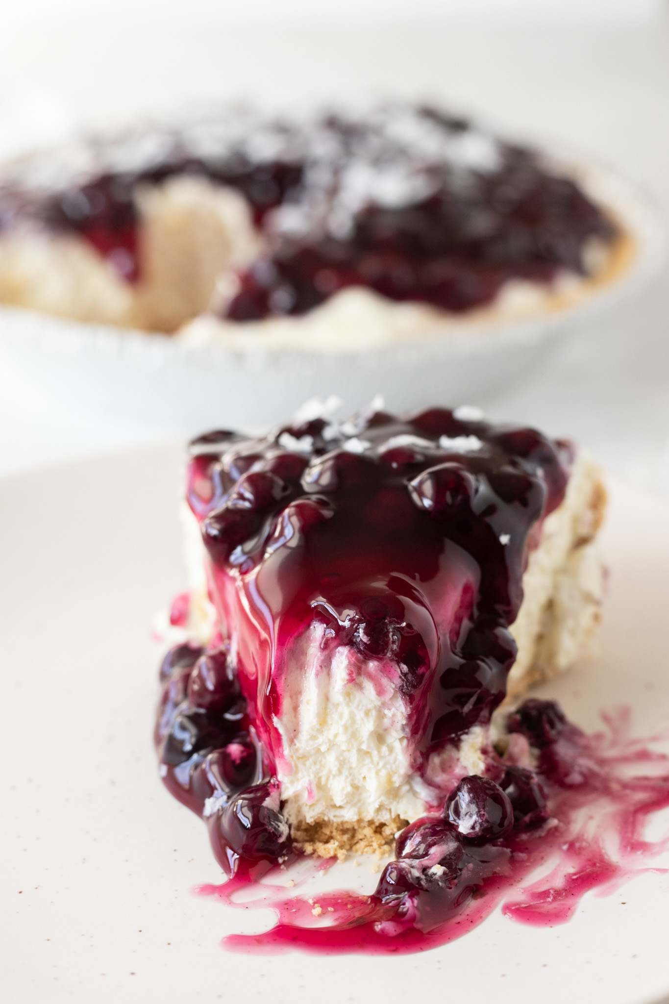 slice of pie topped with blueberry sauce
