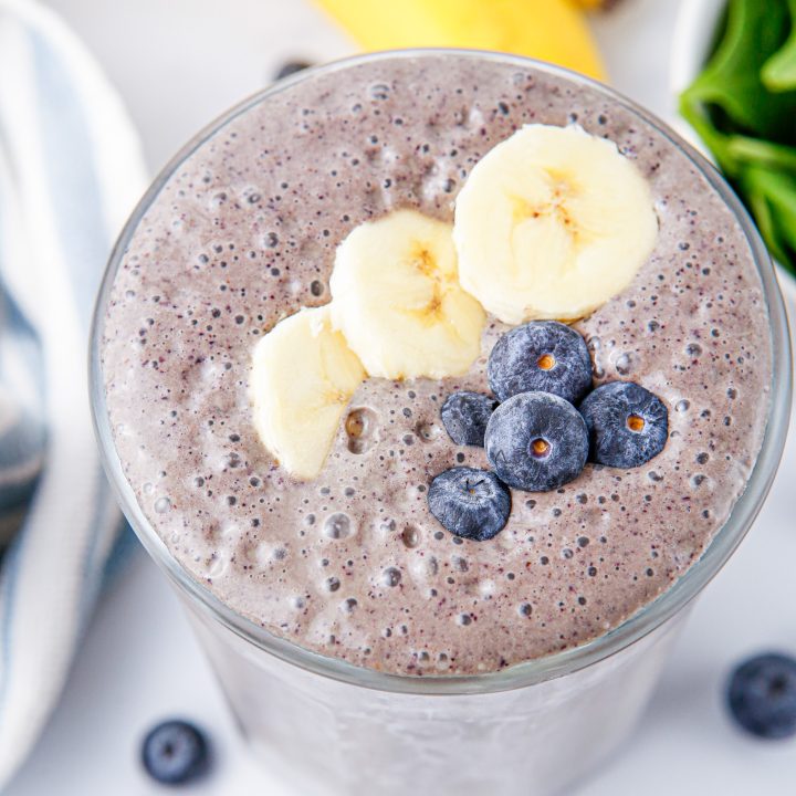 smoothie topped with sliced bananas and blueberries