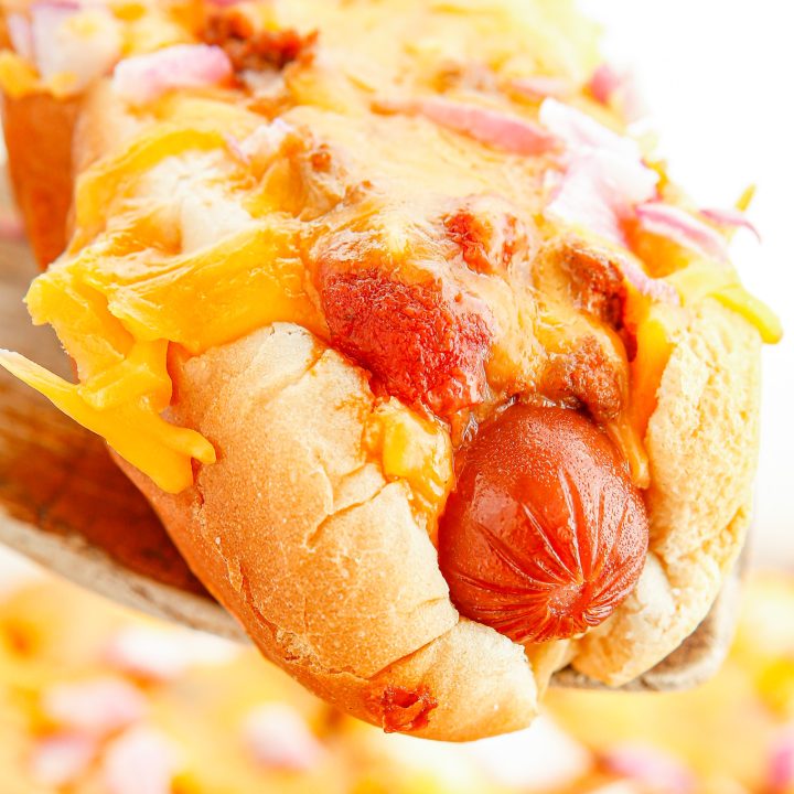 baked hot dog being lifted out of casserole dish