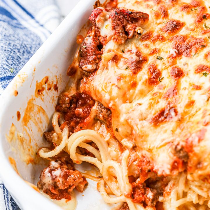 cheesy spaghetti in white casserole dish