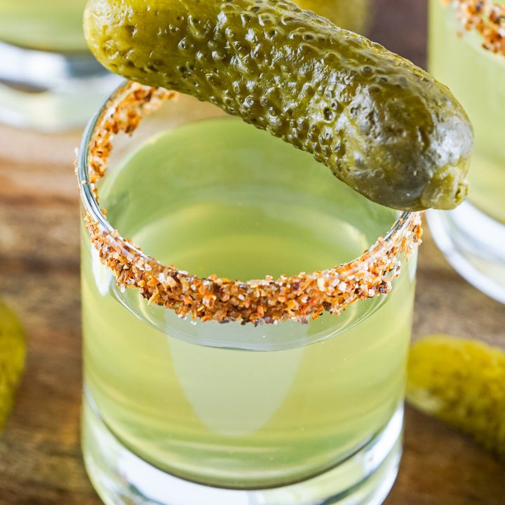 light green shot in glass topped with mini pickle