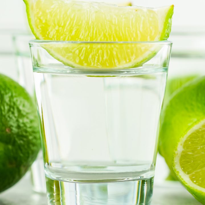 clear shot in glass topped with lime wedge