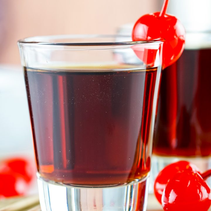 brown liquid in clear shot glass
