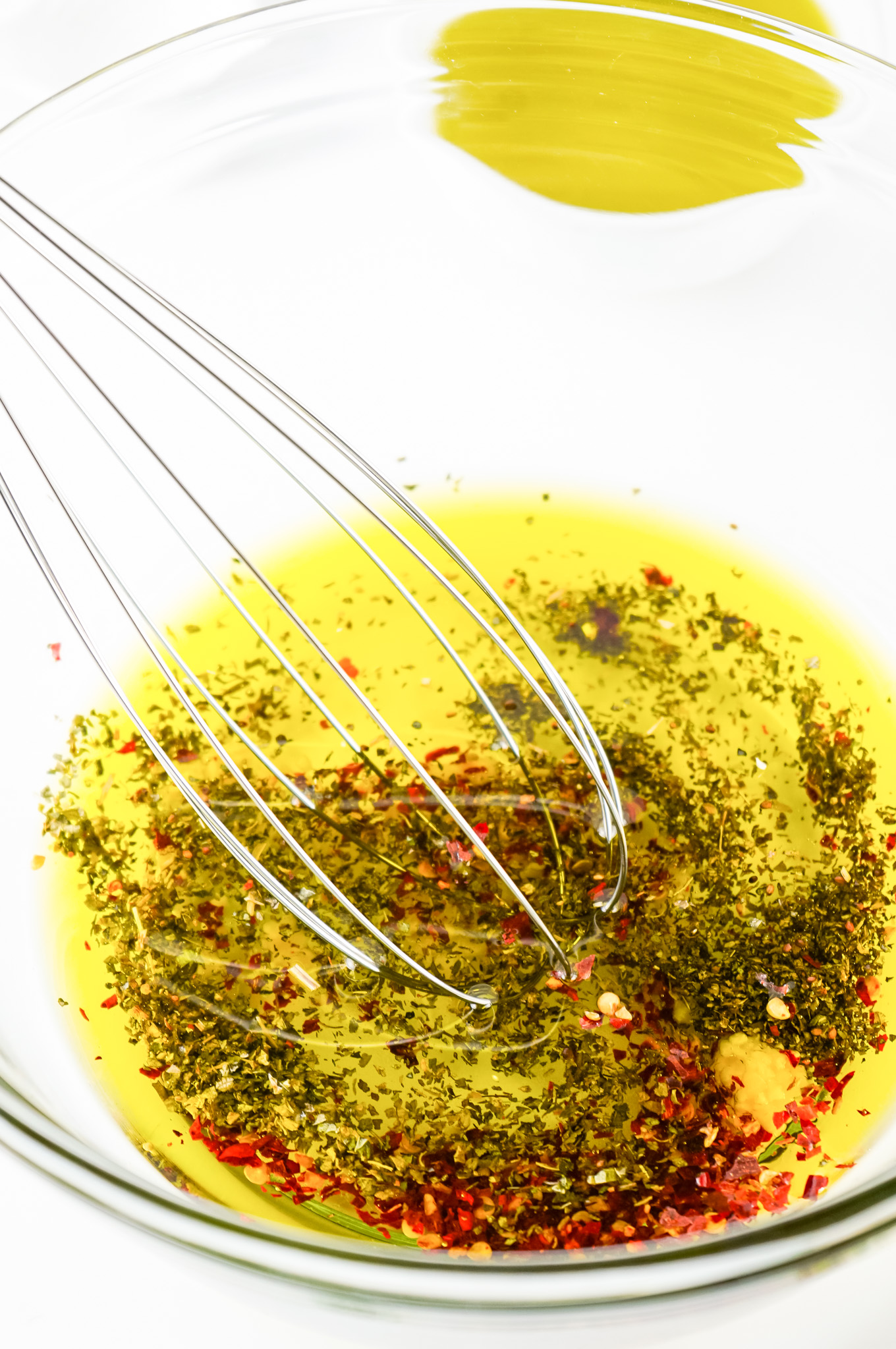 ingredients in glass bowl with whisk 