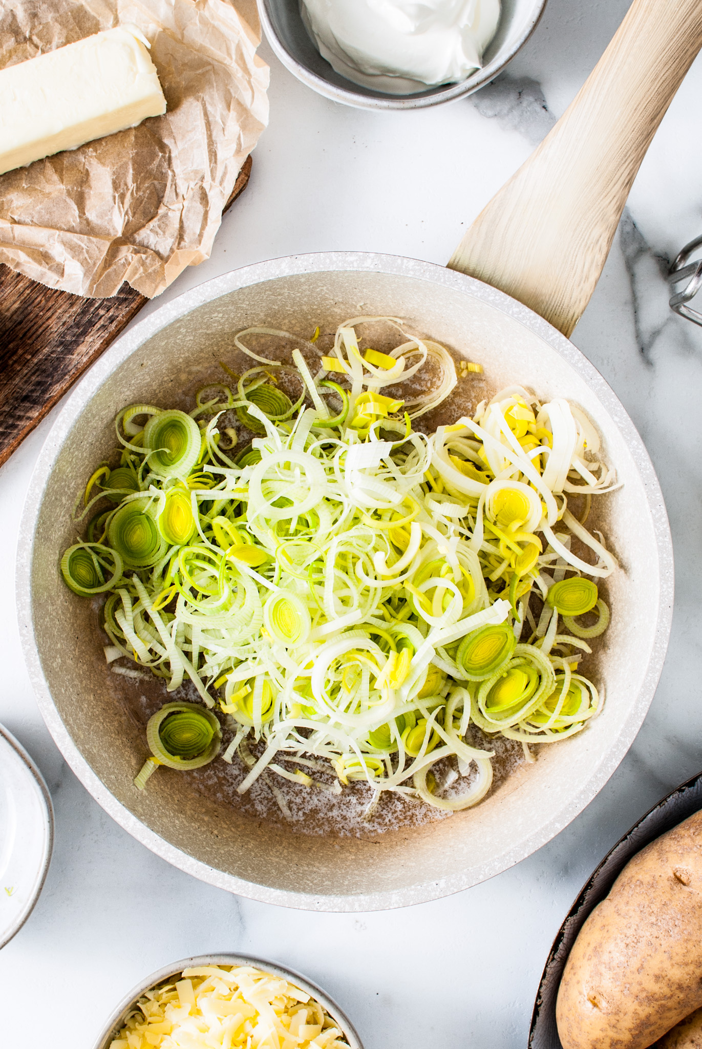 sliced raw leeks in pan