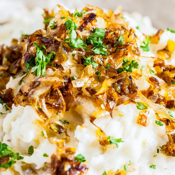 golden browned leeks on top of mashed potatoes