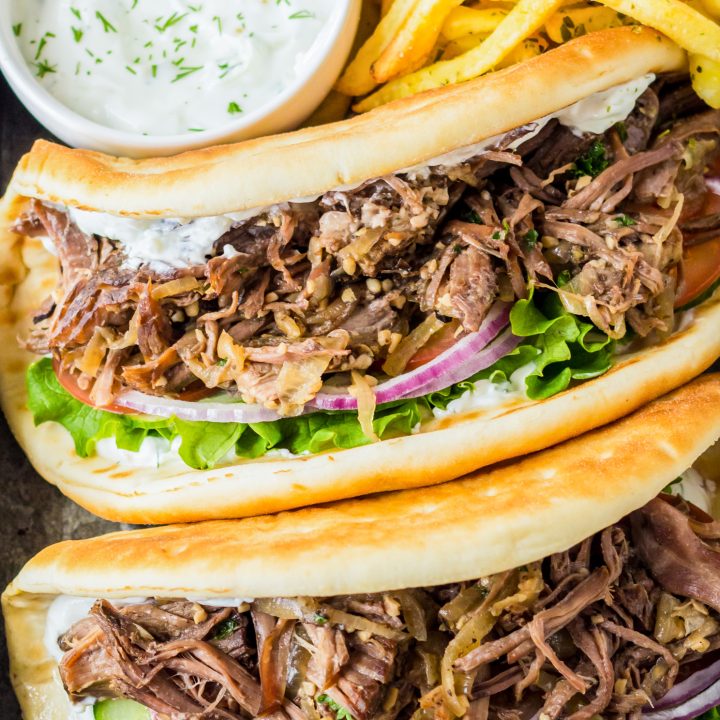 two gyros next to fries