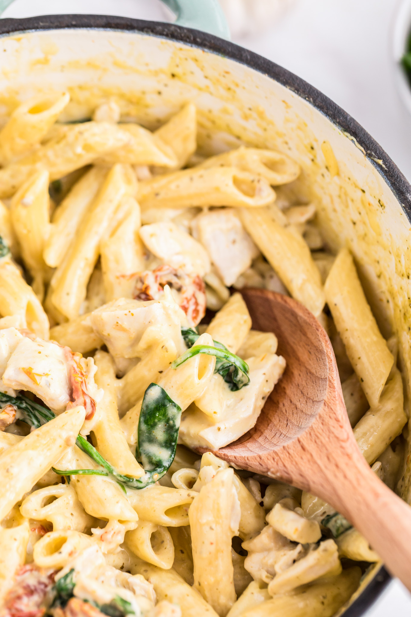 pasta in pot with wooden spoon