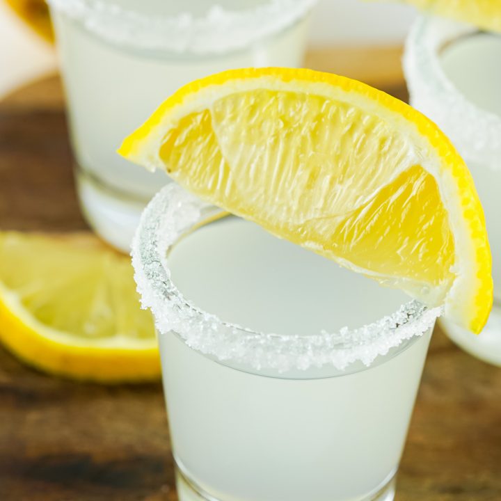 clear shots topped with lemon wedges