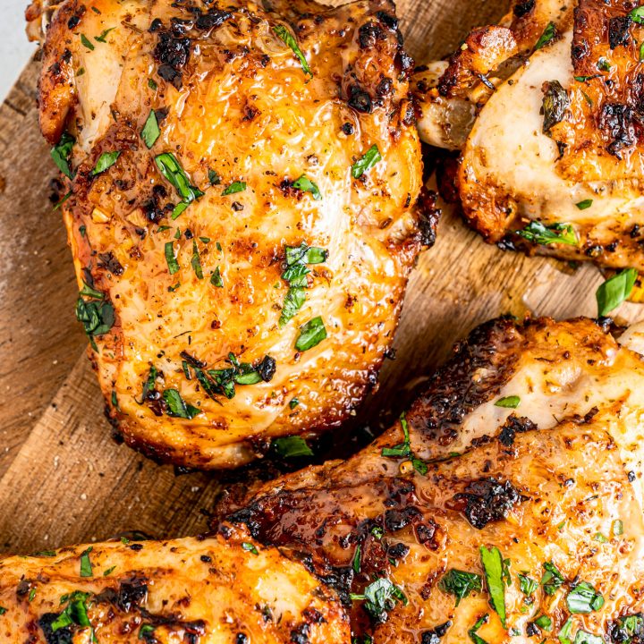 cooked chicken thighs on cutting board