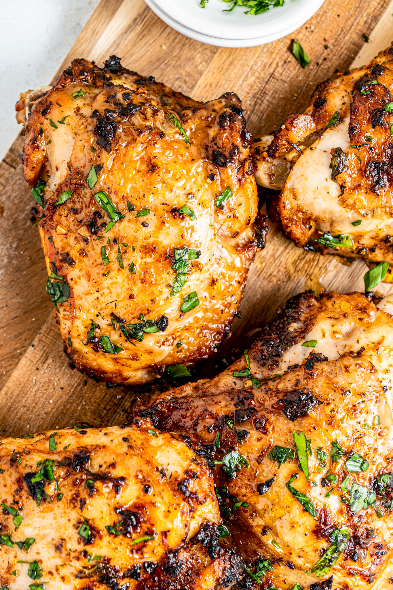 cooked chicken thighs on cutting board