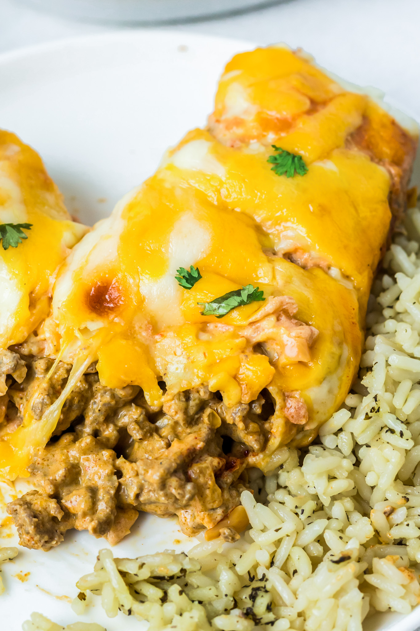 enchilada filled with beef topped with melted cheese