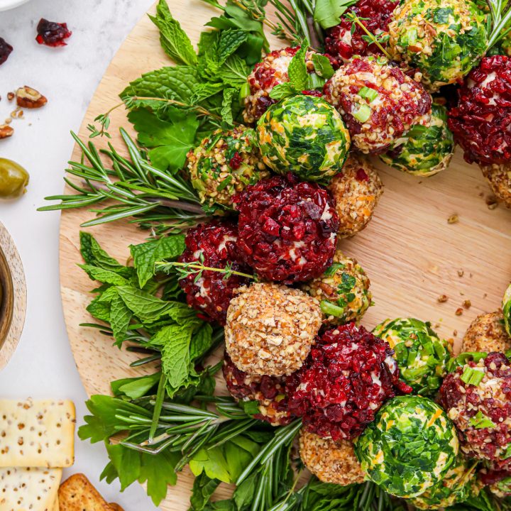 green red and tan cheeballs arranged on wooden board