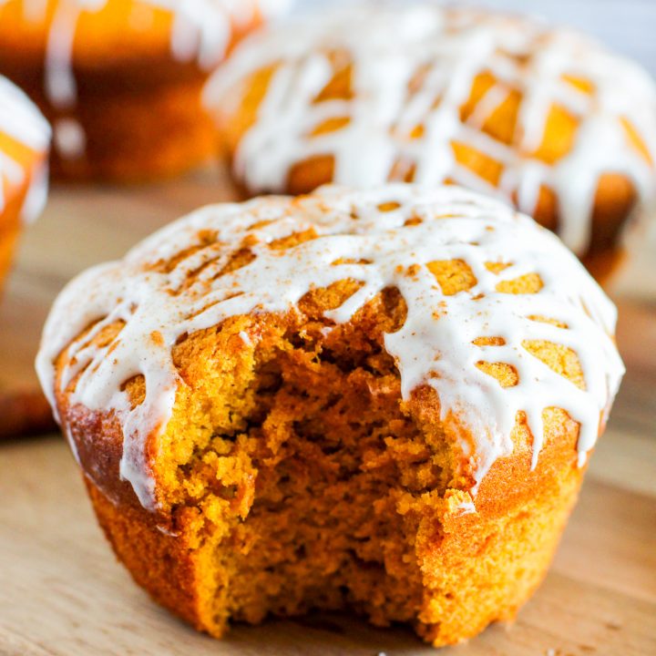 orange colored muffin with white glaze drizzle