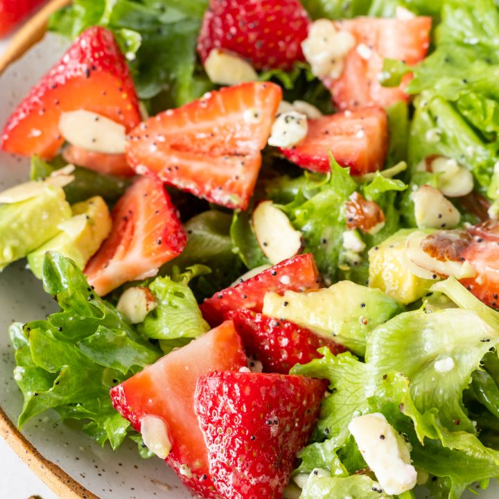 lettuce fresh strawberries and avocado in bowl