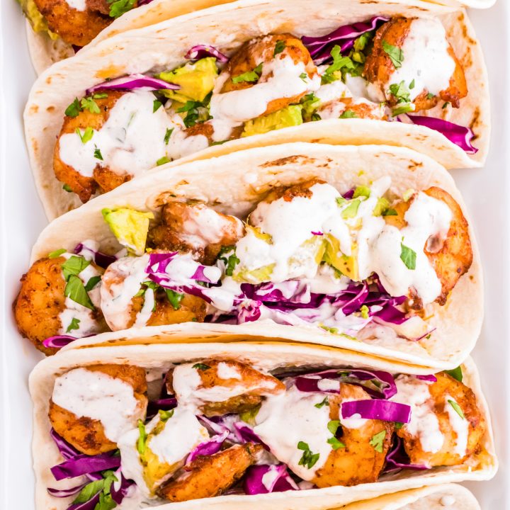 prepared tacos arranged in a line