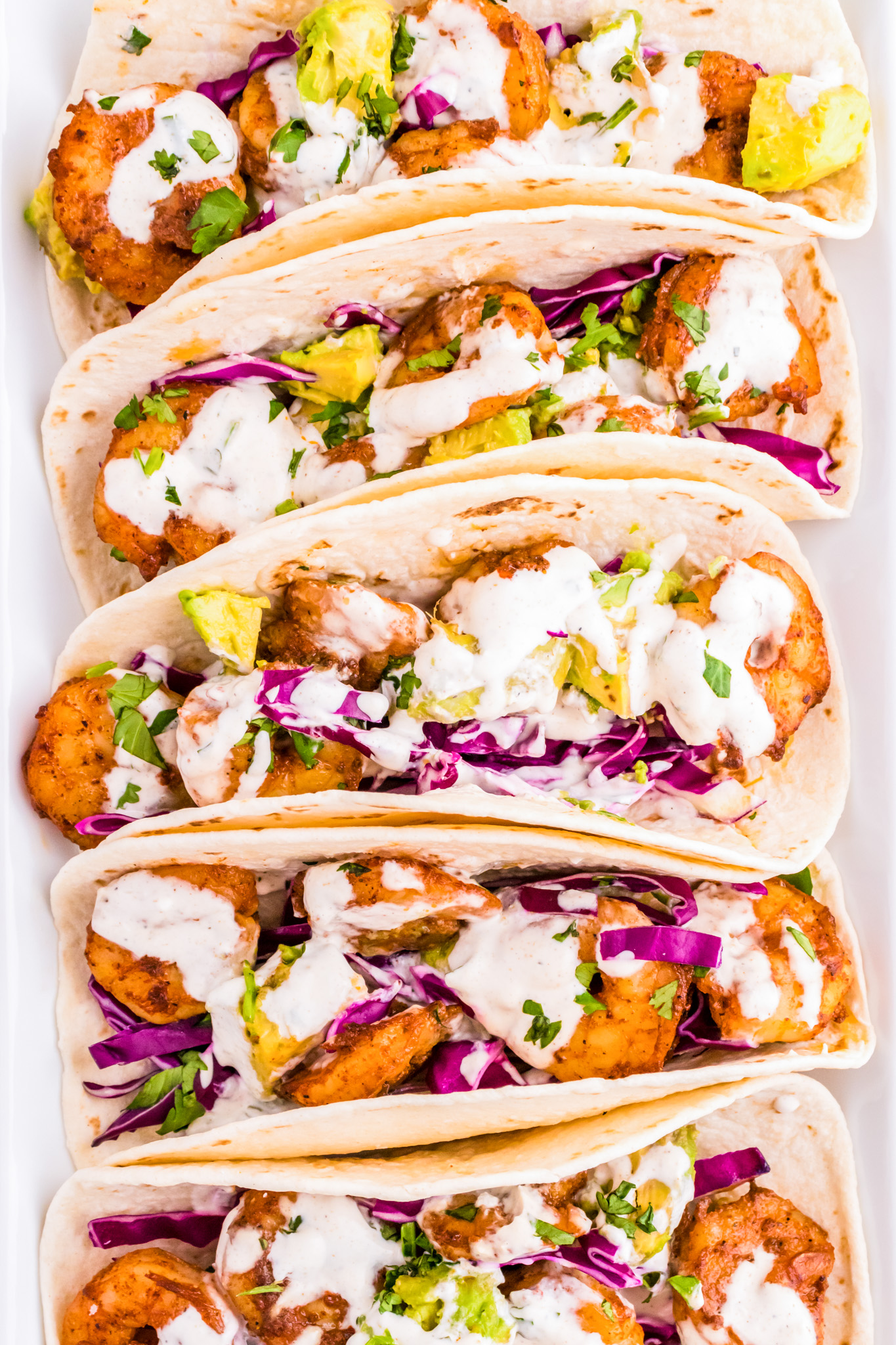 prepared tacos arranged in a line