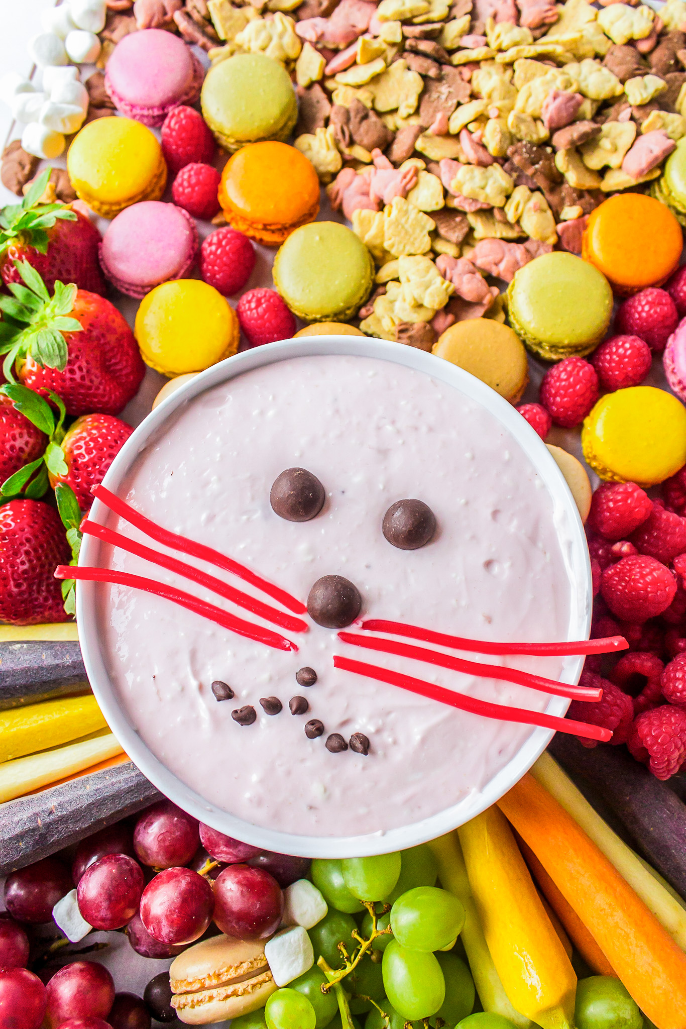 sweets and fruit surrounding bunny face fruit dip