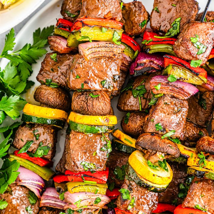 cooked steak and veggies on metal skewers
