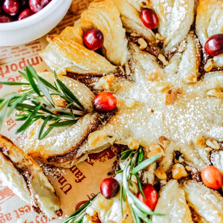 prepared pastry ring garnished with cranberries and rosemary