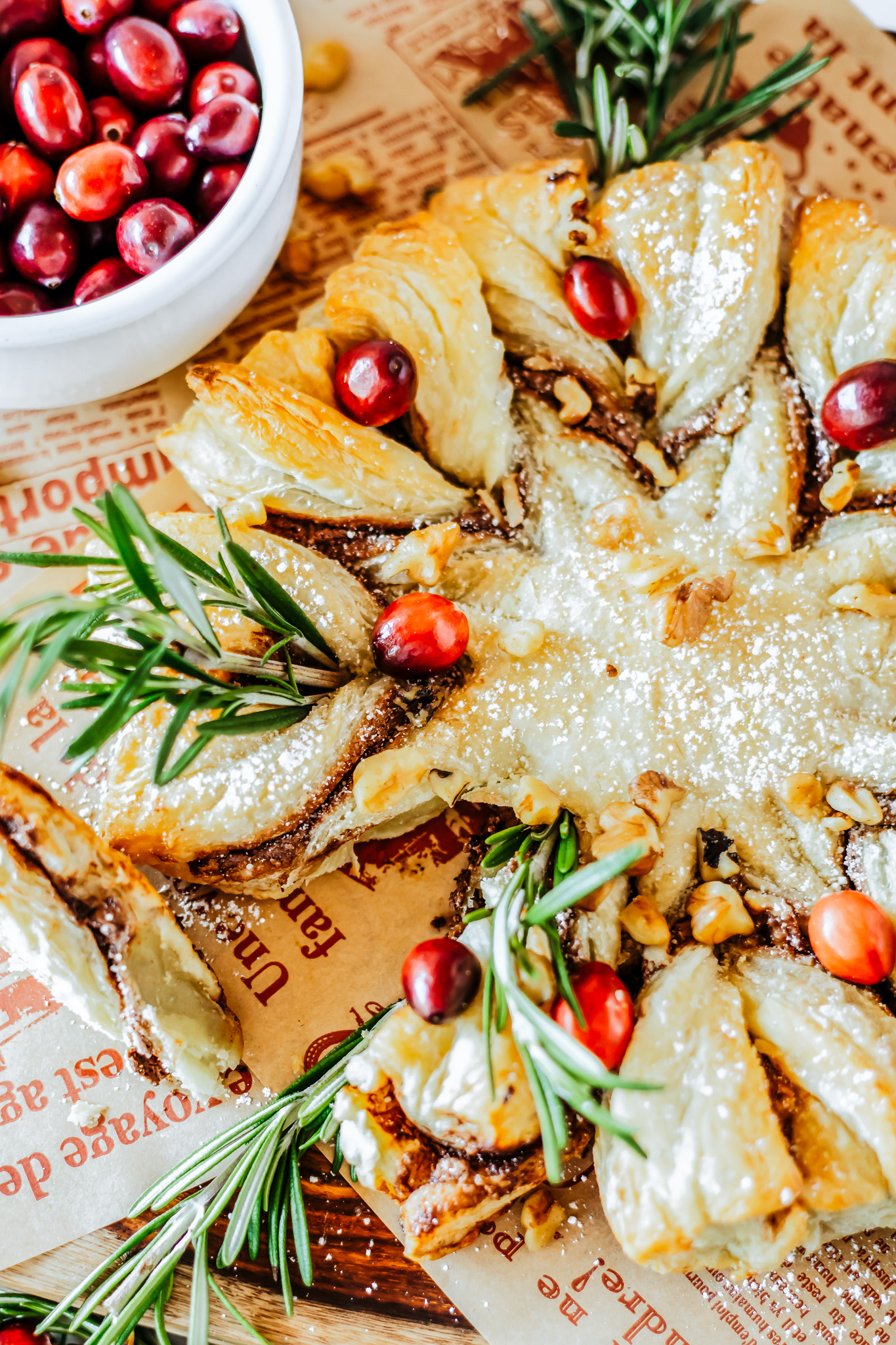 prepared pastry ring garnished with cranberries and rosemary
