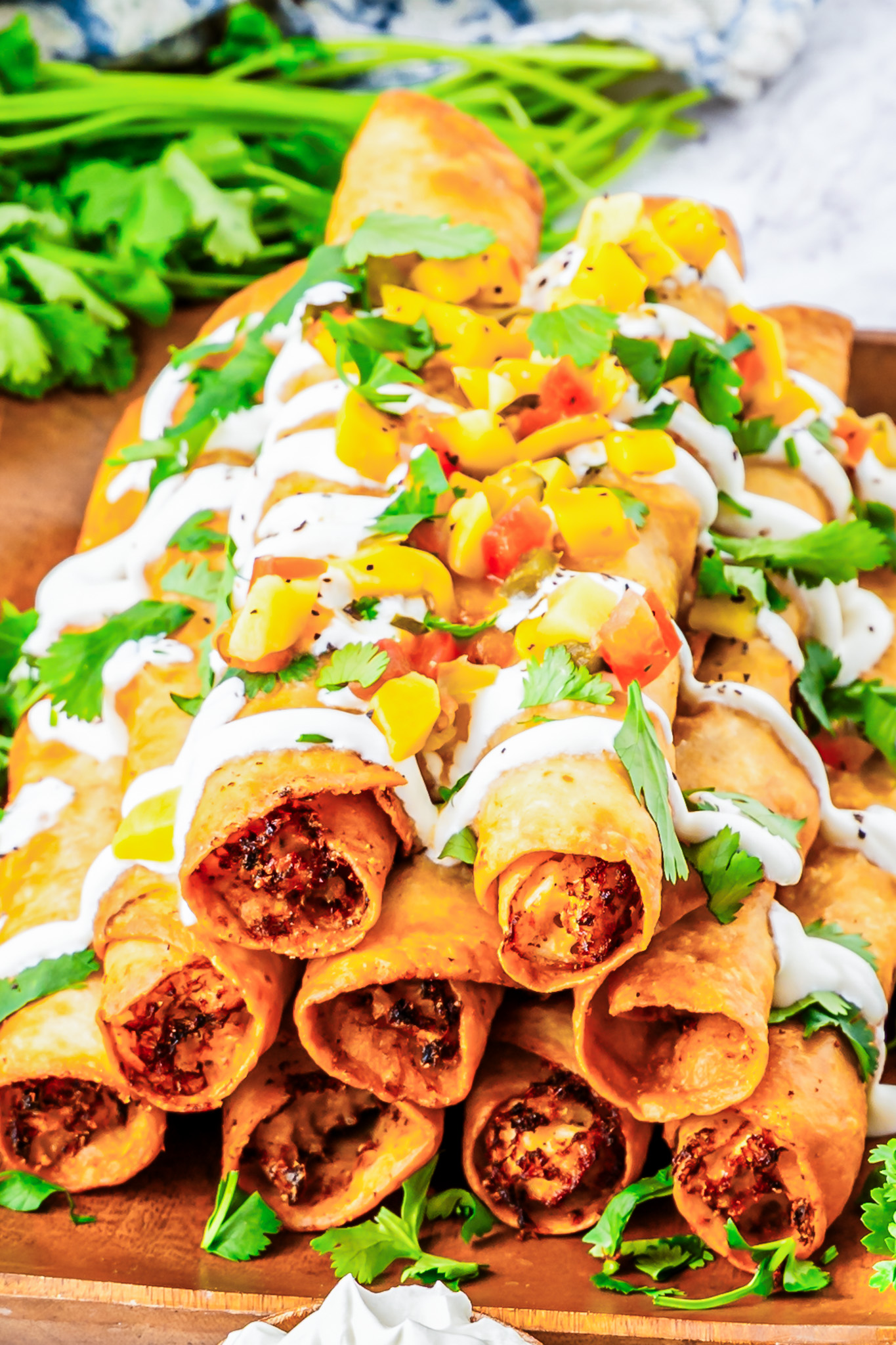 prepared taquitos on wooden board