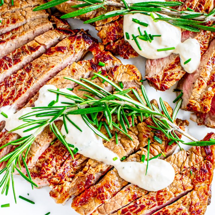 cooked steak topped with sauce