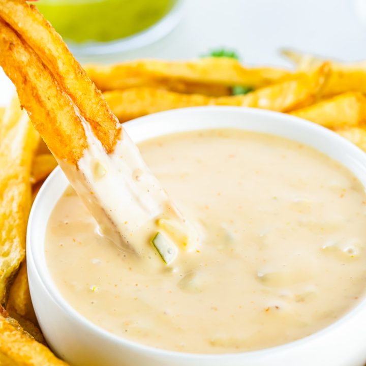 fries dipping into sauce