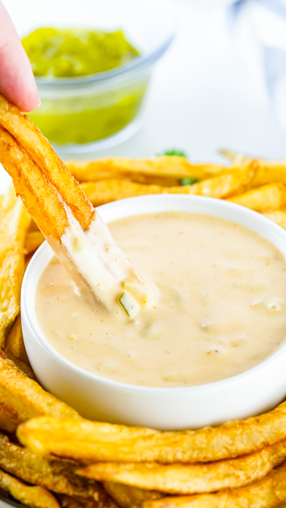 fries dipping into sauce