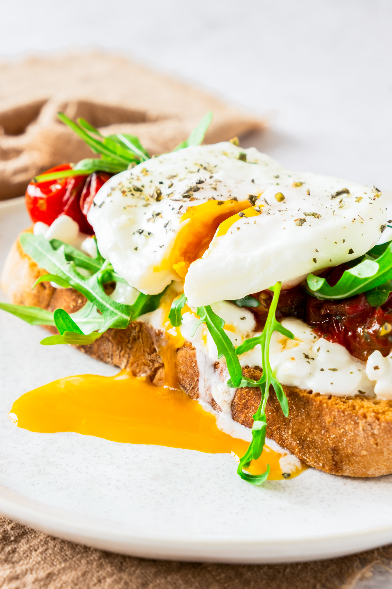 toast topped with egg and dripping yolk