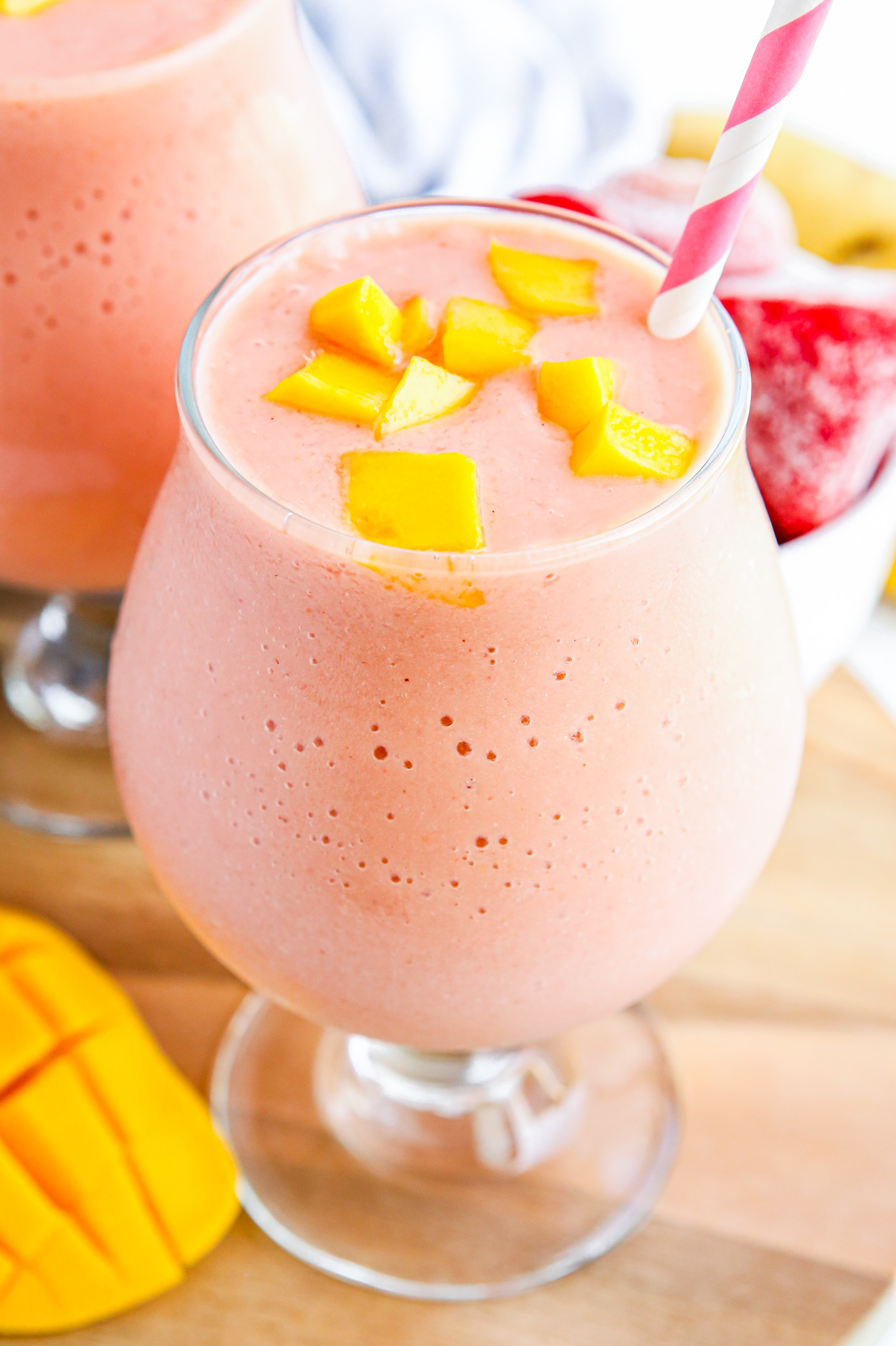 pink smoothie topped with mango chunks