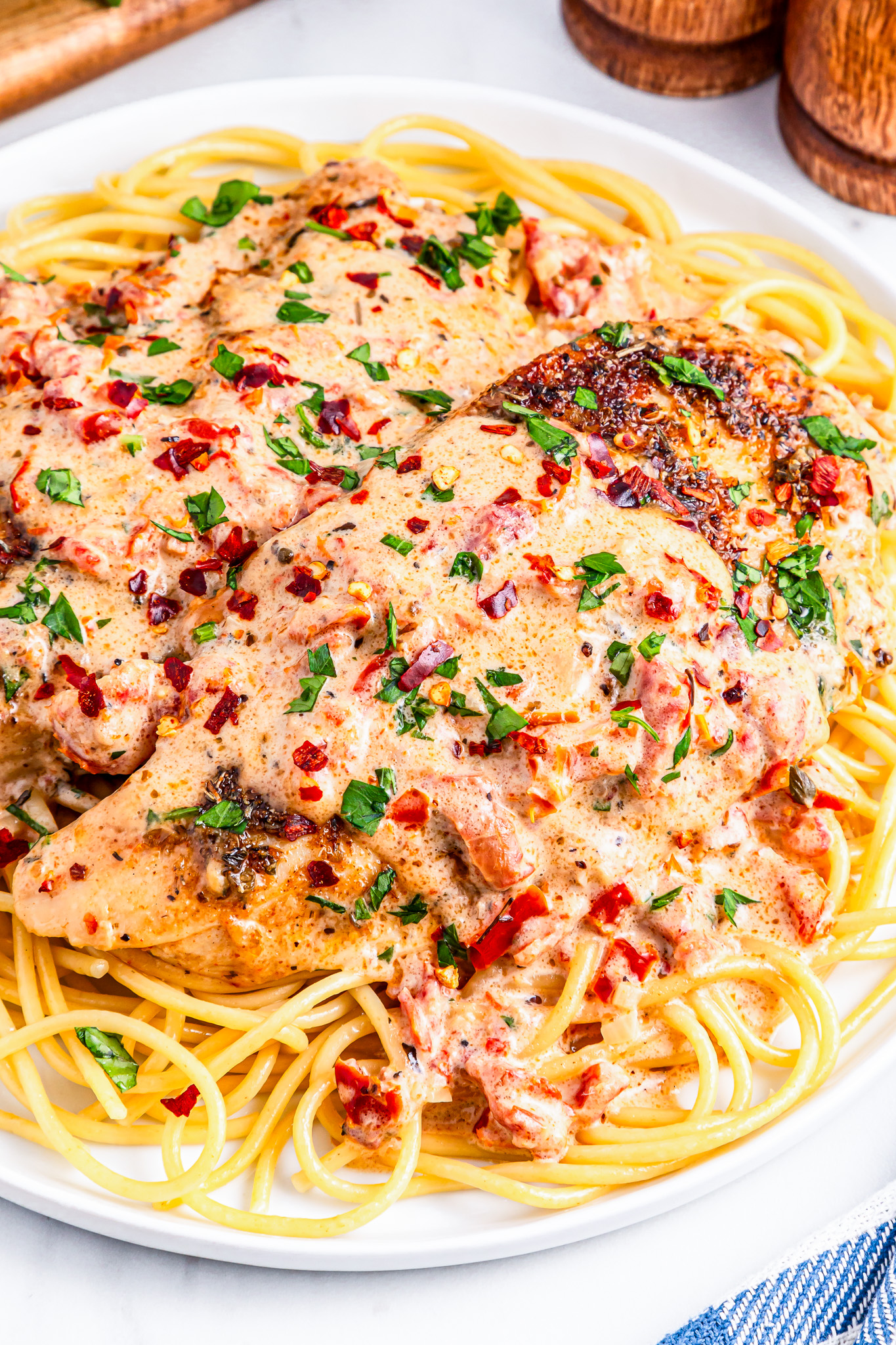 chicken and sauce over pasta