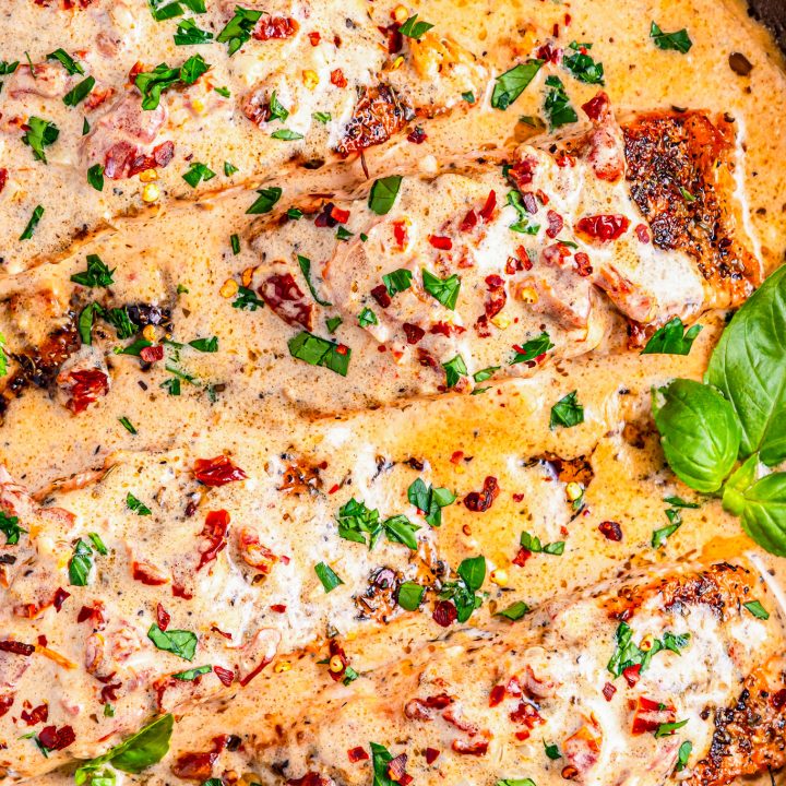 salmon filets in pan with sauce
