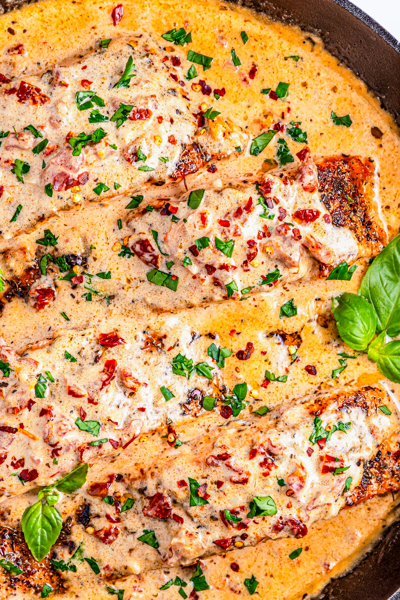 salmon filets in pan with sauce